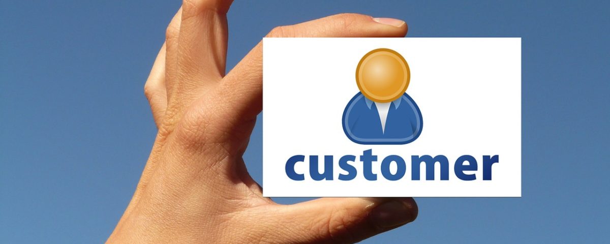 A hand holding a "customer" card
