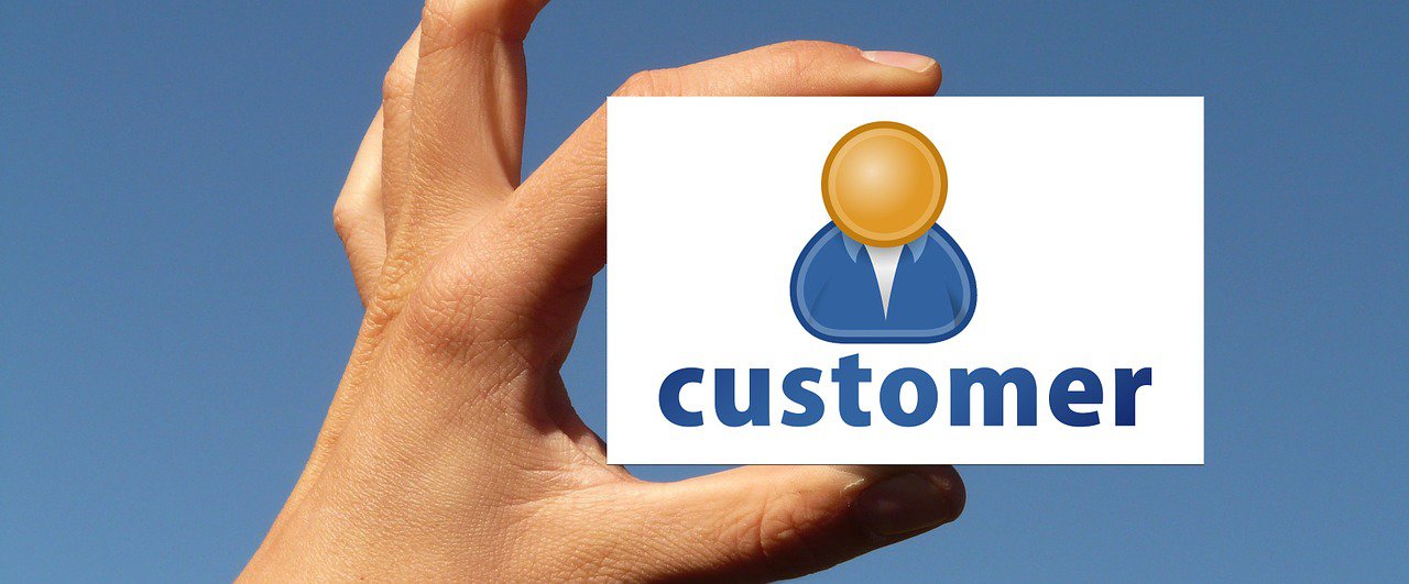 A hand holding a "customer" card