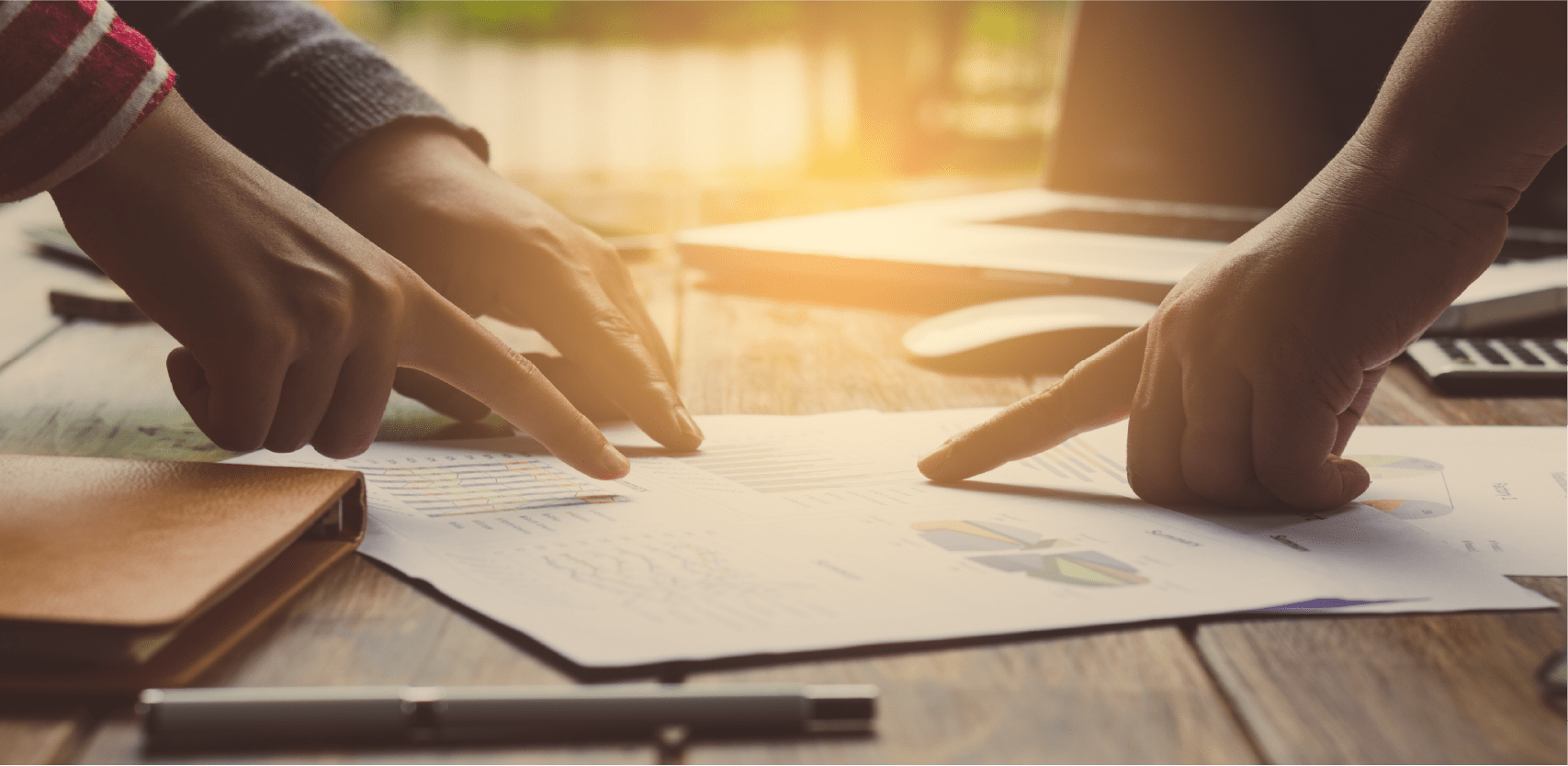 People meeting pointing at a document