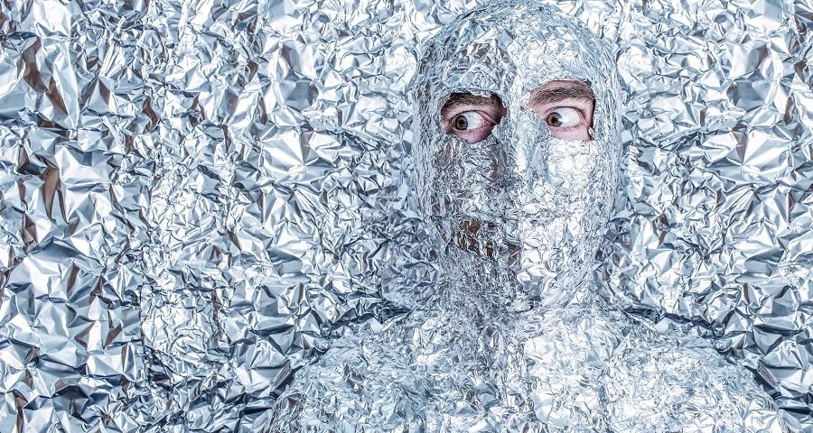 A man covered in aluminum foil paper, only eyes exposed