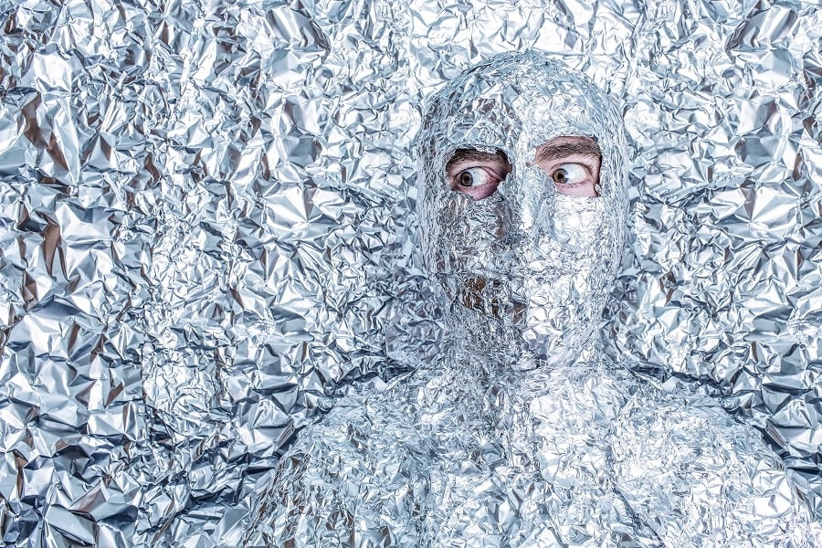 A man covered in aluminum foil paper, only eyes exposed