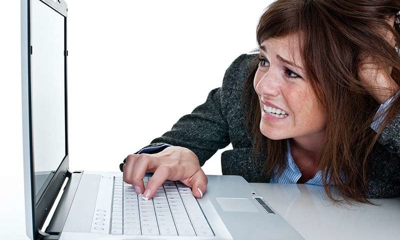 A confused lady staring at a computer screen