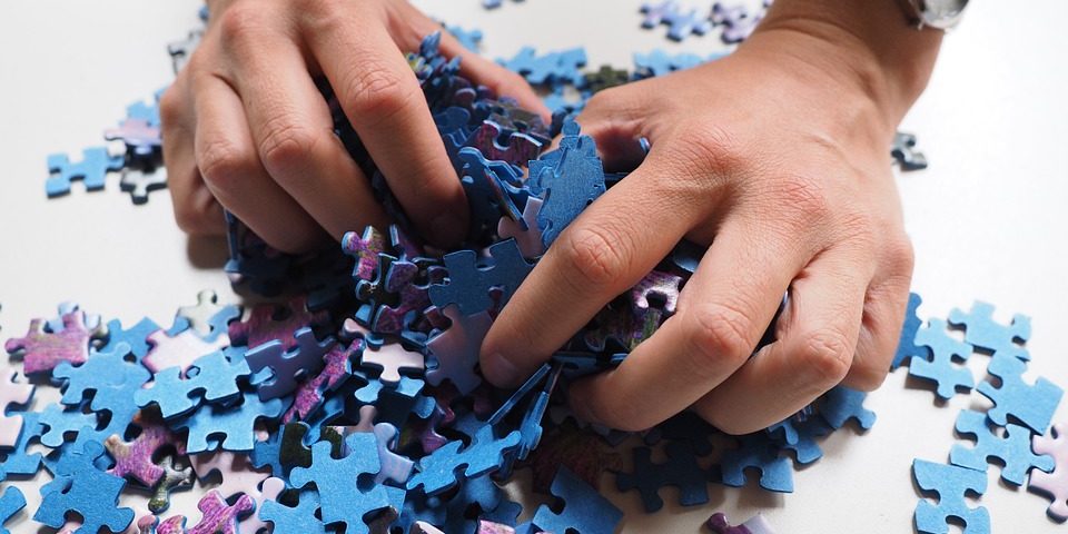 A woman holding puzzle pieces