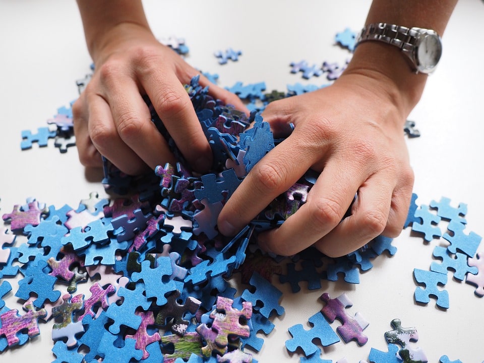 A woman holding puzzle pieces