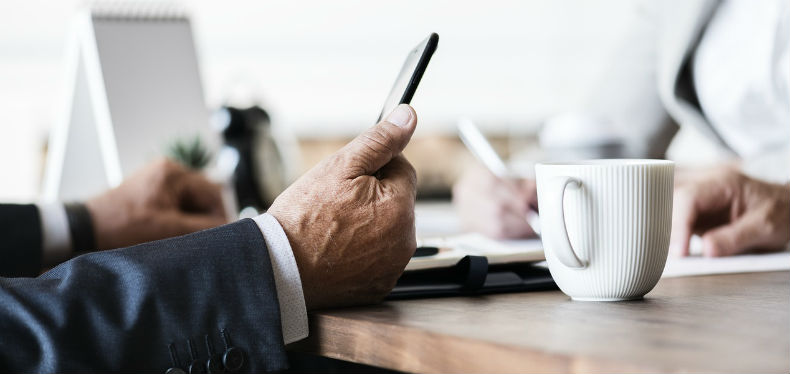 A businessman holding his phone