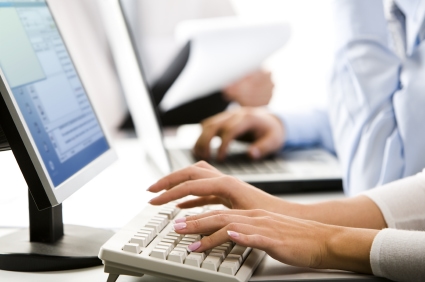 A woman typing on a computer