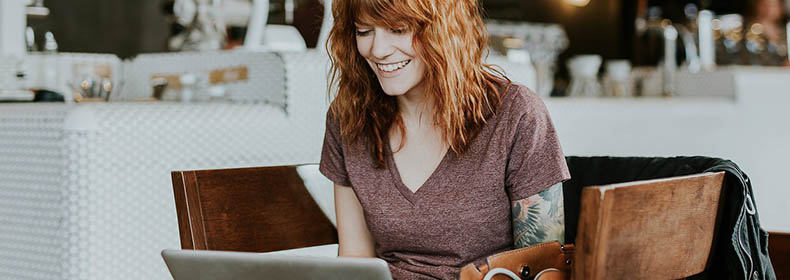 A happy woman working on her computer