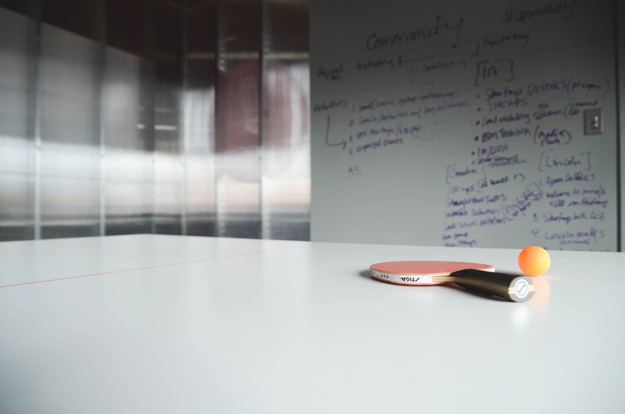 A ping pong paddle on a desk