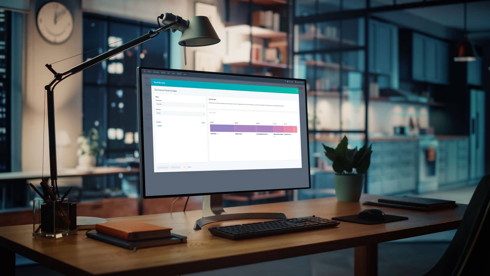 a computer on a desk displaying a Hubspot dashboard